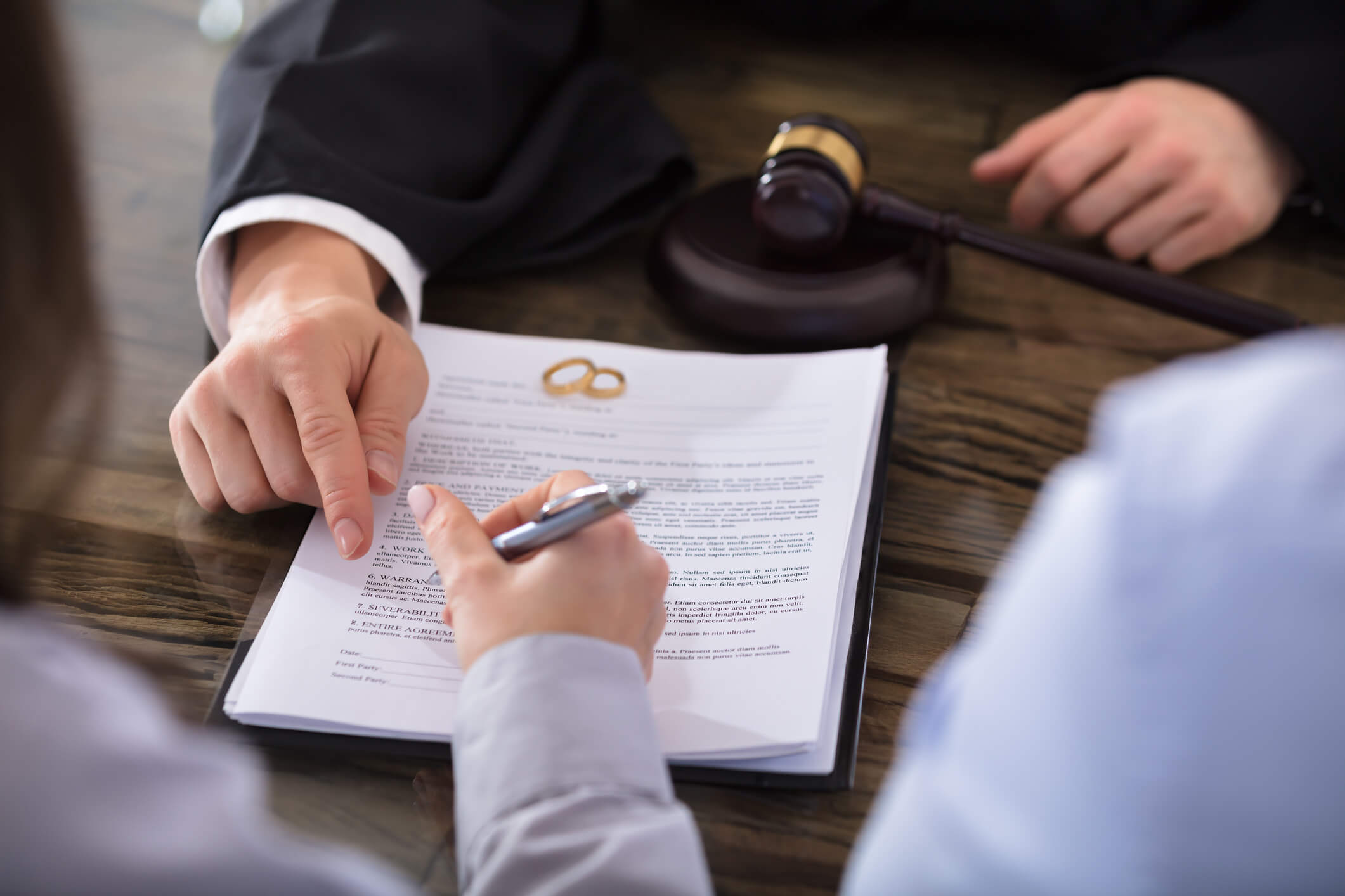 Couple signing divorce papers.